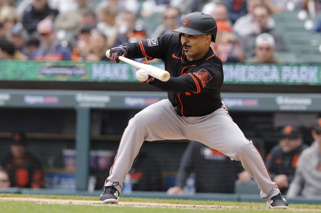 May 28, 2025; Detroit, Michigan, USA;  San Francisco Giants first base LaMonte Wade Jr. (31) bunts in the fourth inning against the Detroit Tigers at Comerica Park. Mandatory Credit: Rick Osentoski-Imagn Images