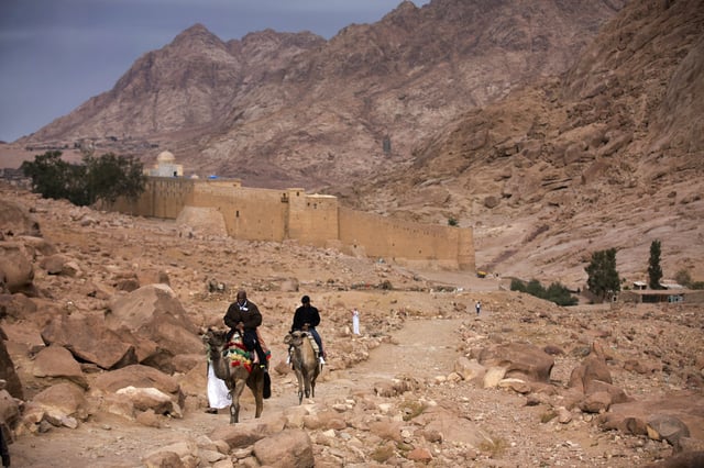FILE - Visitors leave Saint Catherine's Monastery in Saint Catherine, Egypt, Dec. 9, 2013. (AP Photo/Hiro Komae, File)