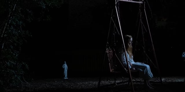 Emma (Abigail Cowen), a possessed woman, rides on a swing in “The Ritual,” a film set in the early 20th century based on what is believed to be the best documented exorcism in history.