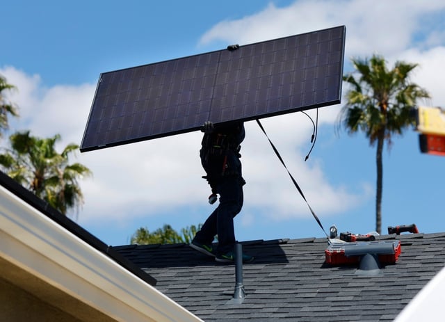 Miguel Cornelio of Stellar Solar works on a solar panel installation in North Park on Monday, April 15, 2024 in San Diego, CA. (K.C. Alfred / The San Diego Union-Tribune)