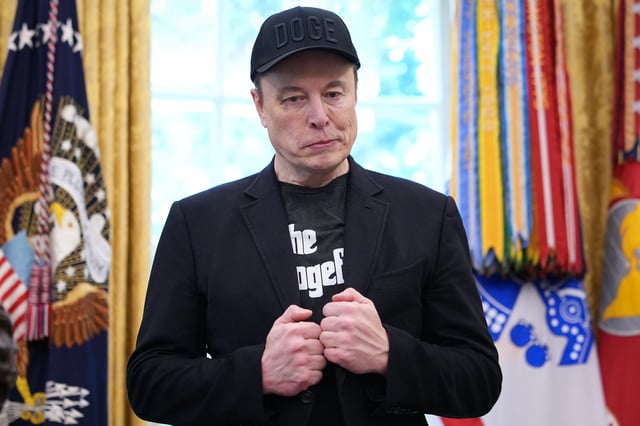 Tesla CEO Elon Musk listens as President Donald Trump speaks to reporters in the Oval Office of the White House on May 30, 2025 in Washington, D.C. (Photo by Kevin Dietsch/Getty Images)