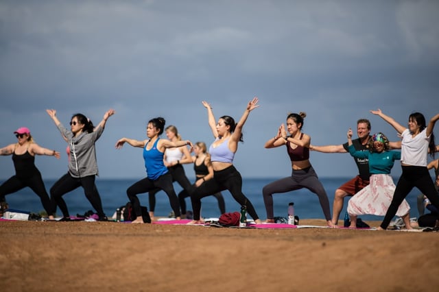 People participate in a yoga class at Sunset Cliffs in Ocean Beach on Sunday, March 6, 2022. Jackie Kowalik, who teaches the yoga class, also offers classes at Civita Park in Mission Valley and the Flower Fields at Carlsbad. More information can be found at yogajawn.com.  (Kristian Carreon / For The San Diego Union-Tribune)