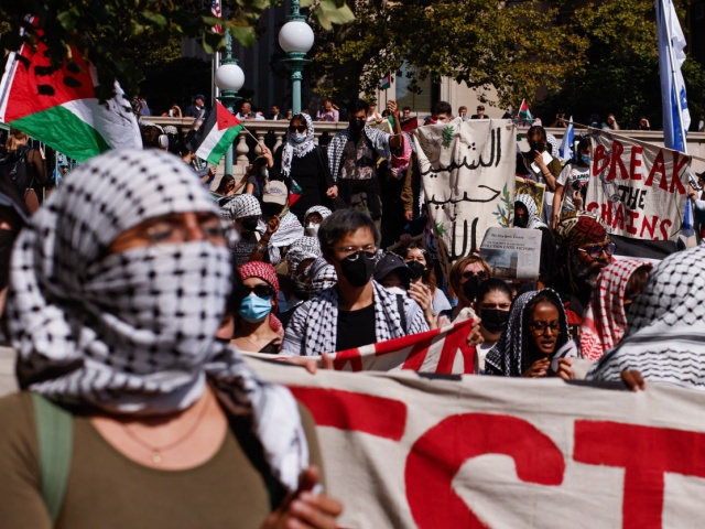 Pro-Palestinian demonstrators march through the Columbia University campus to mark one year of the war between Hamas and Israel in New York City on October 7, 2024. (Photo by kena betancur / AFP) (Photo by KENA BETANCUR/AFP via Getty Images)