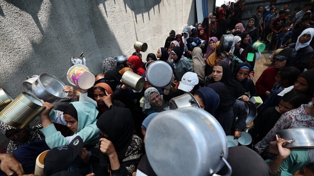 Palestinian women gather at a hot meal distribution point in Nuseirat in the central Gaza Strip, June 4, 2025. The US and Israeli-backed Gaza Humanitarian Foundation (GHF) group operating aid sites in the Gaza Strip announced the temporary closure of the facilities on June 4, following a string of deadly incidents near the distribution sites it operates that have sparked condemnation from the United Nations. (Photo by Eyad BABA / AFP) (Photo by EYAD BABA/AFP via Getty Images)