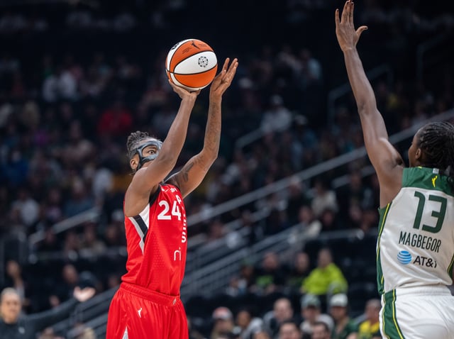 May 25, 2025; Seattle, Washington, USA;  Las Vegas Acesguard Jewell Loyd (24) shoots the ball against Seattle Storm forward Ezi Magbegor (13) during the first half at Climate Pledge Arena. Mandatory Credit: Stephen Brashear-Imagn Images