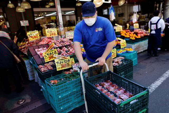An employee of a supermarket named Akidai works at a store in Tokyo, Japan January 20, 2023. REUTERS/Issei Kato/File Photo