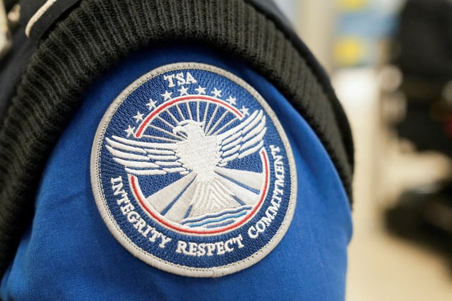 A patch on the shirt of a TSA agent reads "Integrity Respect Commitment" at Hartsfield-Jackson Atlanta International Airport in Atlanta, Georgia, U.S. February 1, 2025. REUTERS/Megan Varner/File Photo