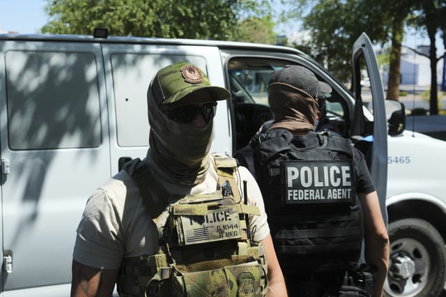 File – ICE and Homeland Security Investigations police make an arrest outside an immigration court in Phoenix on May 21.