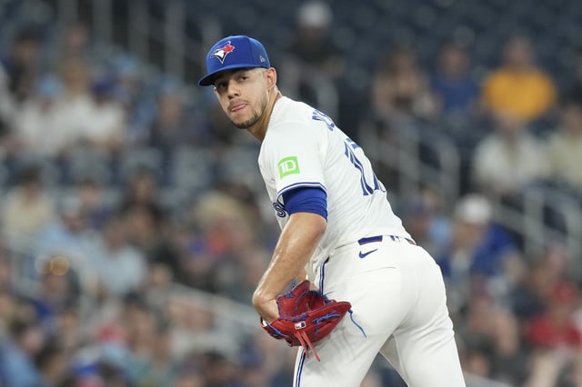 Toronto Blue Jays pitcher Jose Berrios (17) checks on a Philadelphia Phillies runner on first base during third inning MLB baseball action in Toronto on Wednesday, June 4, 2025. THE CANADIAN PRESS/Chris Young