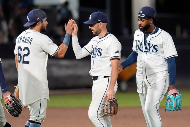 Tampa Bay&#39;s Jonathan Aranda (62) celebrates with second baseman  Brandon Lowe and third baseman  Junior Caminero after their victory on Wednesday.  (AP Photo/Chris O&#39;Meara)