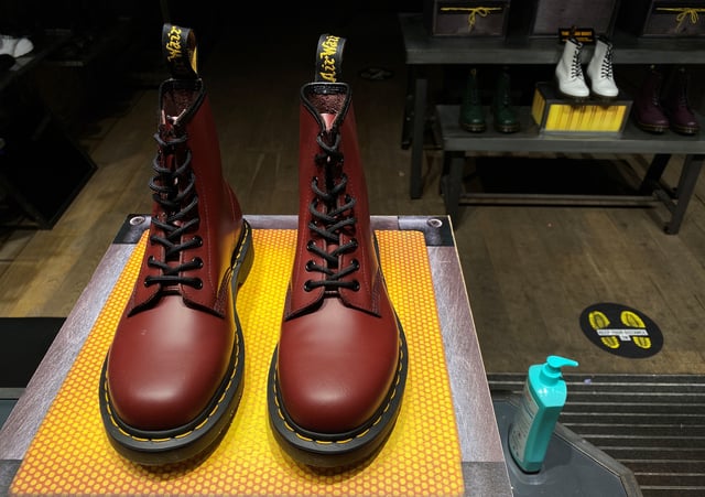 A pair of Dr. Martens boots seen through the window of a Dr Martens shop in London, Britain, September 17, 2020. REUTERS/Simon Newman/ File Photo