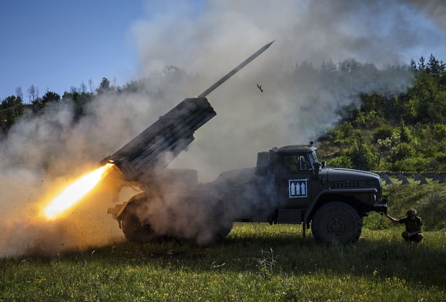 Militares ucranianos disparan un sistema de cohetes múltiples autopropulsados hacia una posición rusa.