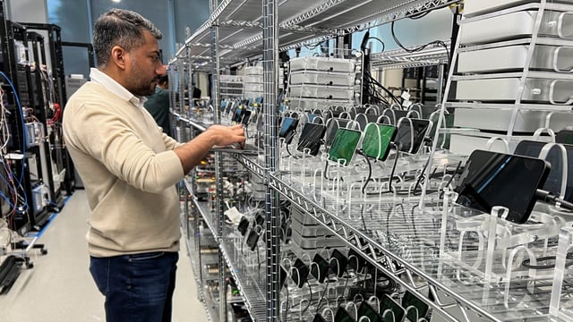 An Apple engineer stress tests an iPhone 16e and the new C1 cellular modem at an Apple lab in Sunnyvale, California.