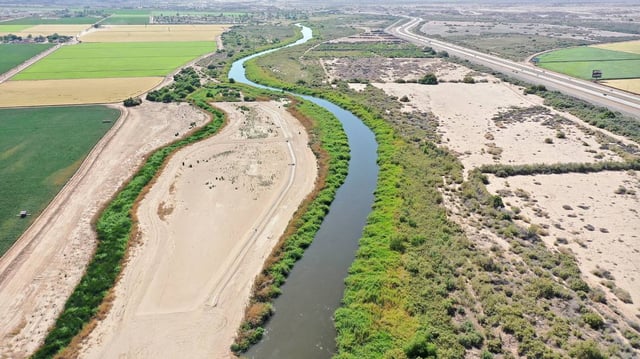 An aerial view of the long-depleted Colorado River, currently swollen by winter snowmelt water, as it flows near farmland along the border between Arizona, left, and California on May 26, 2023, near Yuma, Arizona. (Mario Tama/Getty Images/TNS)