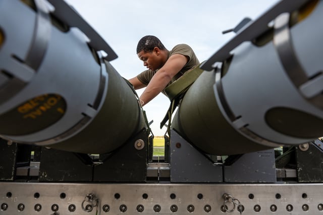 A United States airman prepares GBU-38 Joint Direct Attack Munitions to be loaded onto a B-2 stealth bomber at Whiteman Air Force Base in Missouri for a QUICKSINK test on April 22, 2025.