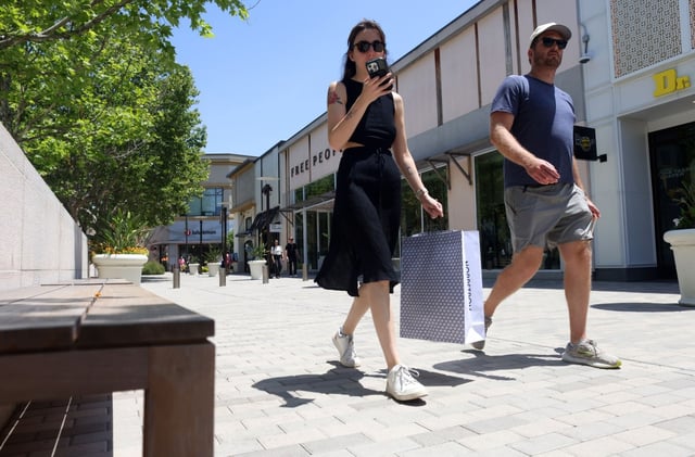 A shopper carries her cell phone while walking through Broadway Plaza on Wednesday, June 4, 2025, in Walnut Creek, Calif.  The city of Walnut Creek is tracking visitors via their cell phones and holding that information to use for marketing purposes.  (Aric Crabb/Bay Area News Group)