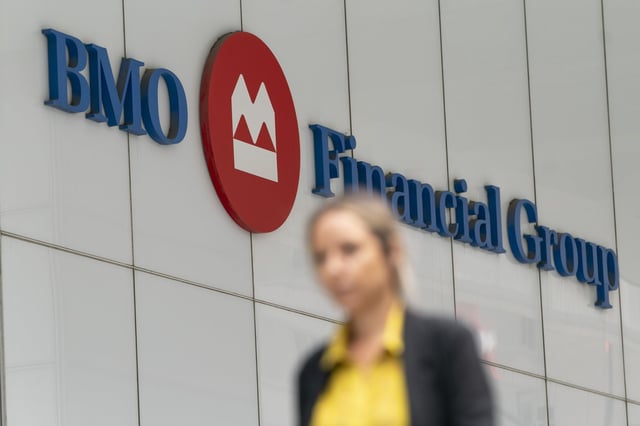 A person makes their way past the Bank of Montreal (BMO) building in the Financial District of Toronto, on Monday, Aug. 14, 2023. THE CANADIAN PRESS/Spencer Colby