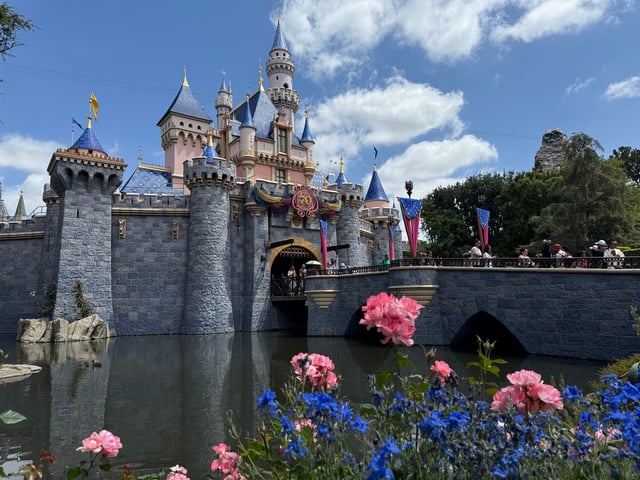 Sleeping Beauty Castle is adorned with Disneyland 70th anniversary flourishes.