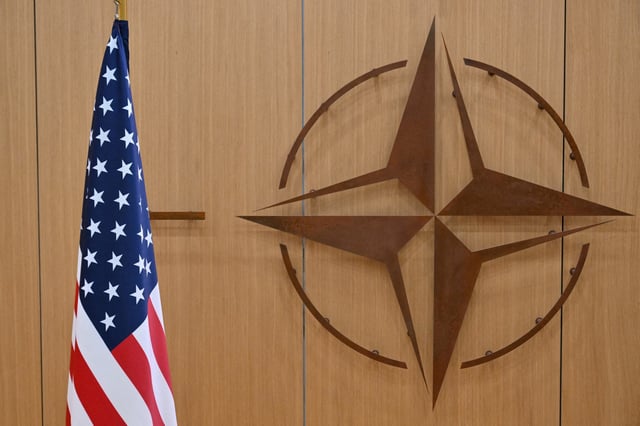 This photo shows the logo of the North Atlantic Treaty Organisation (NATO) and the US flag at NATO headquarters in Brussels, Belgium on February 17, 2025.     NICOLAS TUCAT/Pool via REUTERS/File Photo