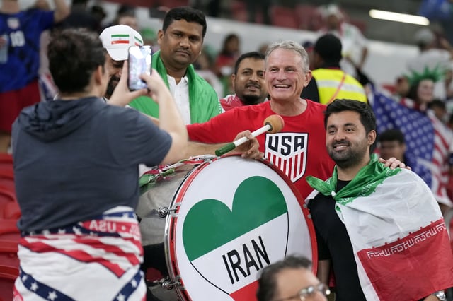 Iranian and United States soccer fans pose for a photo before the World Cup group B soccer match between Iran and the United States at the Al Thumama Stadium in Doha, Qatar, Tuesday, Nov. 29, 2022.
