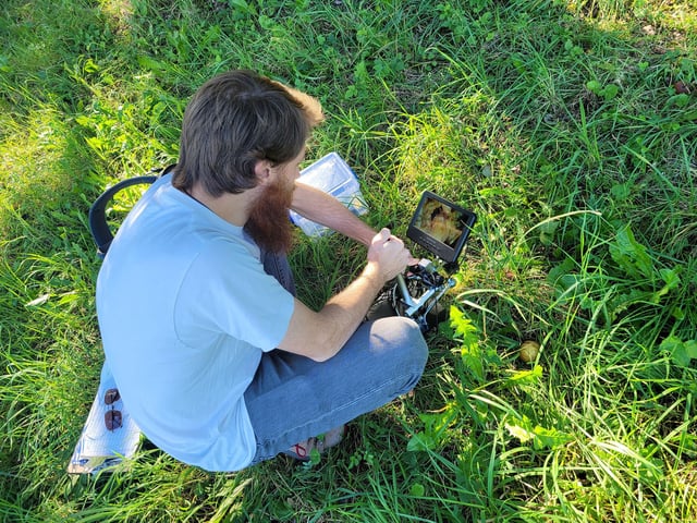 Study coauthor Ryan Greenway, a technical assistant at Max Planck Institute of Animal Behavior in Germany, sets up a field microscope that could record videos of the natural worm towers.
