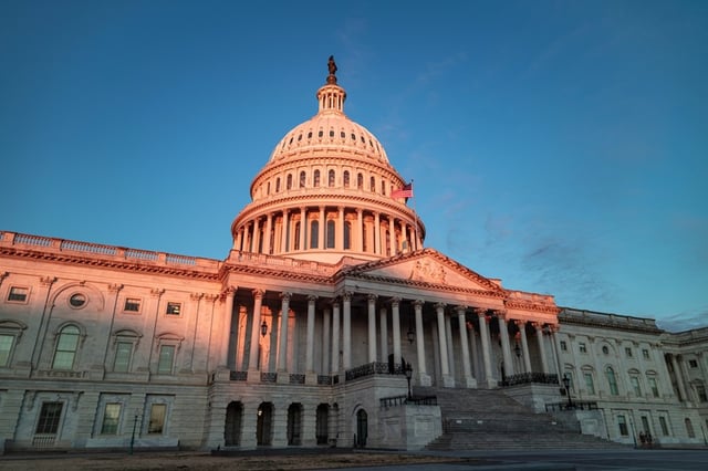 The beautiful sight of the US Capitol building bathed in morning sunlight. The east side of the iconic structure is illuminated by the rising sun, creating a stunning scene in Washington, DC.