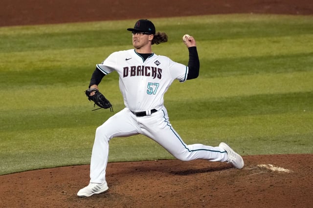 Oct 30, 2023; Phoenix, Arizona, USA; Arizona Diamondbacks relief pitcher Andrew Saalfrank (57) pitches in the ninth inning against the Texas Rangers in game three of the 2023 World Series at Chase Field. Mandatory Credit: Joe Camporeale-USA TODAY Sports/File Photo