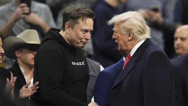 Elon Musk shakes hands with President Donald Trump at the finals for the NCAA wrestling championship on March 22, 2025, in Philadelphia.