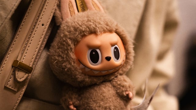 A photo of a Labubu keychain on someone's purse.