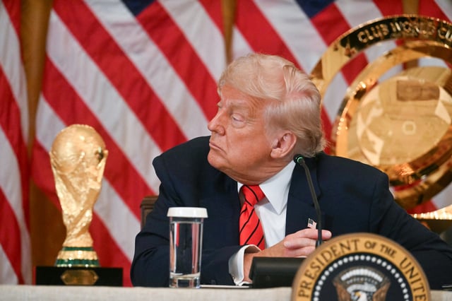 US President Donald Trump listens to Vice President JD Vance speak during a meeting with the White House Task Force on the FIFA World Cup 2026 in the East Room of the White house in Washington, DC, on May 6, 2025. The soccer world championship will take place from June 11 to July 19, 2026, and will be hosted by the US, Canada and Mexico.