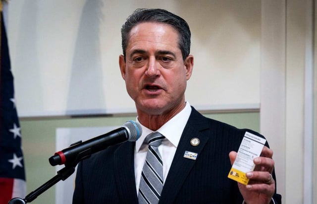 OCDA Todd Spitzer holds a quick reference guide of voting provisions during a press conference and tour of the Orange County Registrar of Voters in Santa Ana, CA on Monday, Feb. 26, 2024. (Photo by Paul Bersebach, Orange County Register/SCNG)
