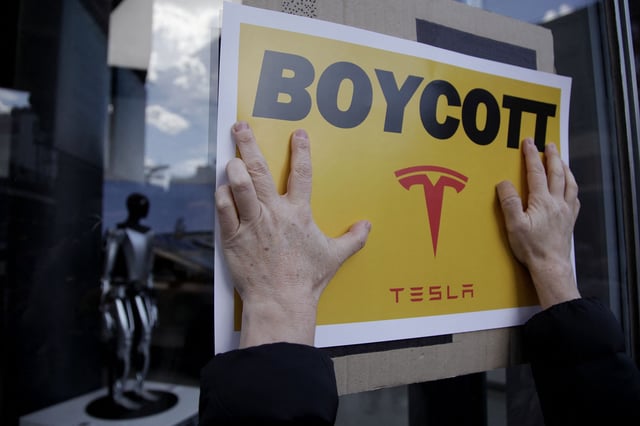 People participate in a "TeslaTakedown" protest against Elon Musk outside of a Tesla dealership in New York on March 1.