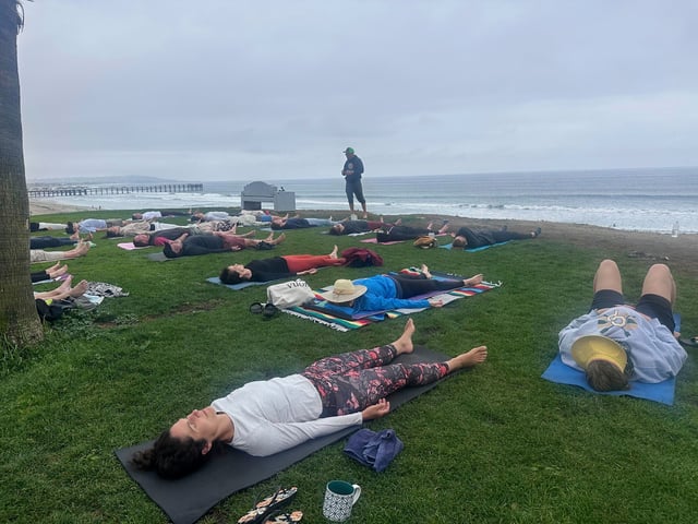 People participate in a beachfront yoga class in San Diego, California, Thursday, June 5, 2025. (AP Photo/Elliot Spagat)