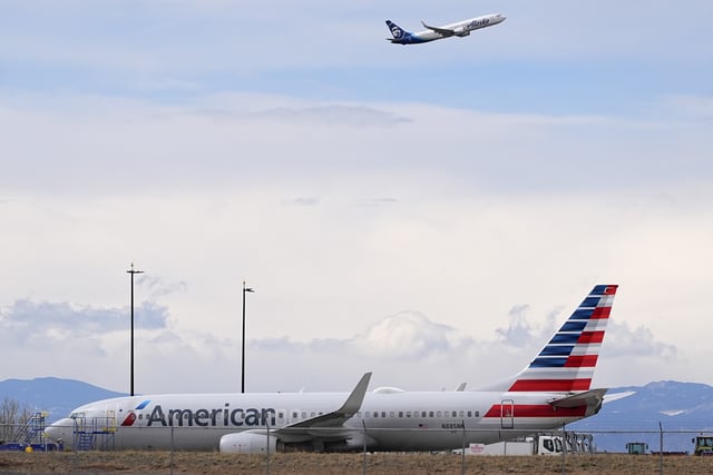 FILE - An American Airlines jetliner that caught fire after landing the previous day at Denver International Airport sits near a hangar at the airport, March 14, 2025, in Denver. (AP Photo/David Zalubowski, File)