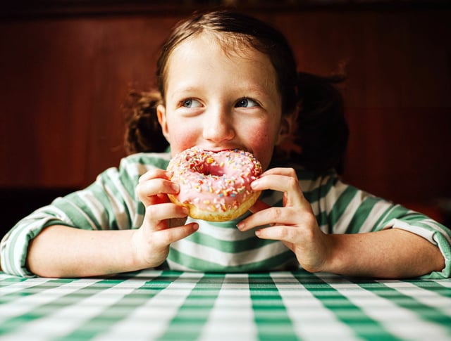 A child eats a doughnut.