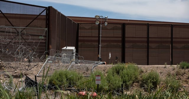 Near Marker 4 east of the Texas-New Mexico state line, a sign, illegible from the Mexican bank of the Rio Grande, warns that the U.S. Department of Defense has taken over the area, May 12, 2025.