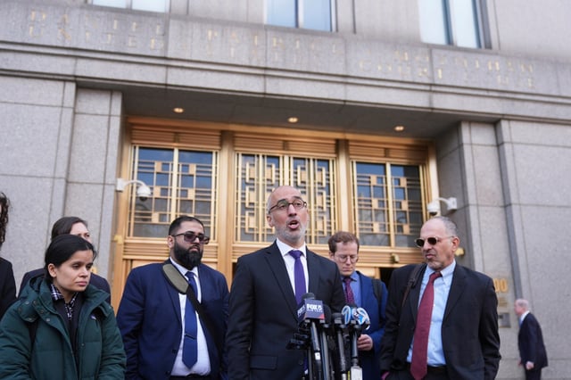 Ramzi Kassem, third from right, a lawyer representing Yunseo Chung, talks to reporters outside federal court in New York, Tuesday, March 25, 2025. (AP Photo/Seth Wenig)