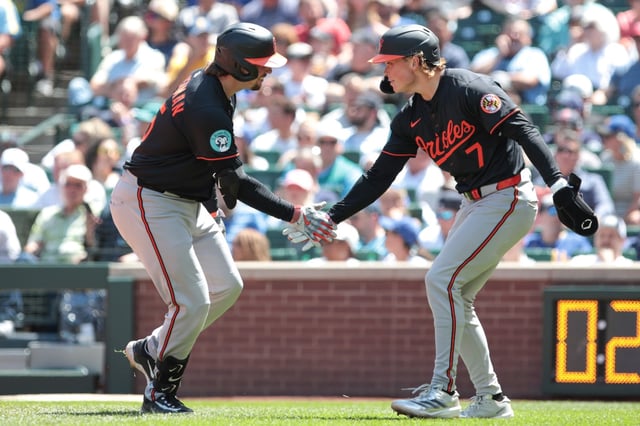 Baltimore Orioles&#39; Adley Rutschman, left, and Jackson Holliday celebrate after scoring on Rutschman&#39;s two-run home run during the sixth inning of a baseball game against the Seattle Mariners, Thursday, June 5, 2025, in Seattle. (AP Photo/Jason Redmond)