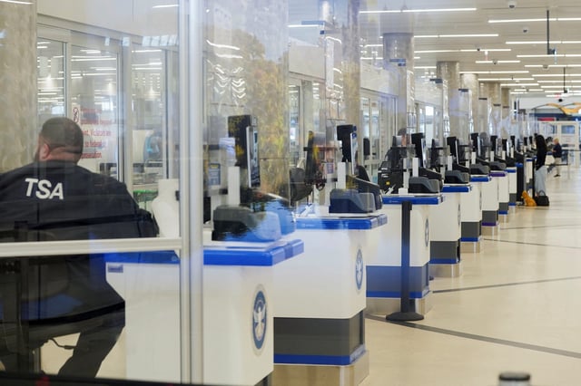 A TSA agent sits at the security counter at Hartsfield-Jackson Atlanta International Airport in Atlanta, Georgia, U.S. February 1, 2025. REUTERS/Megan Varner