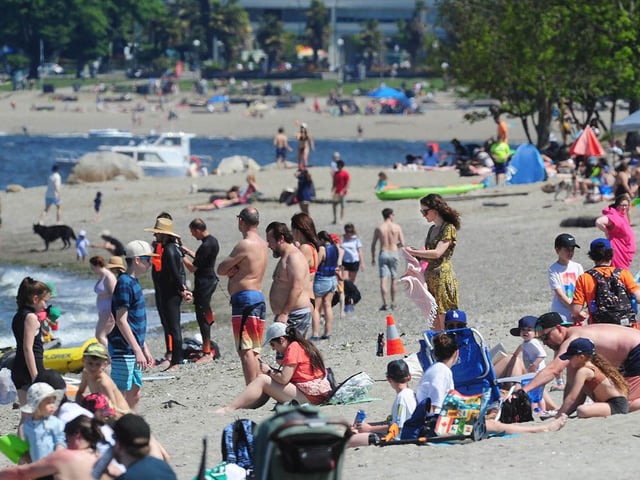 File photo of people enjoying warm late spring weather at Kits Beach in Vancouver.