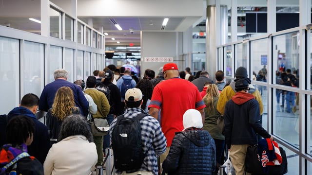Travelers stand in line for security screening at Hartsfield-Jackson Atlanta International Airport (ATL) in Atlanta, Georgia, US, on Friday, Dec. 22, 2023. An estimated 112.7 million people will travel 50 miles or more from Dec. 23 to Jan. 2, up by 3.6 million from last year and getting close to pre-pandemic levels, according to AAA. Photographer: Dustin Chambers/Bloomberg via Getty Images