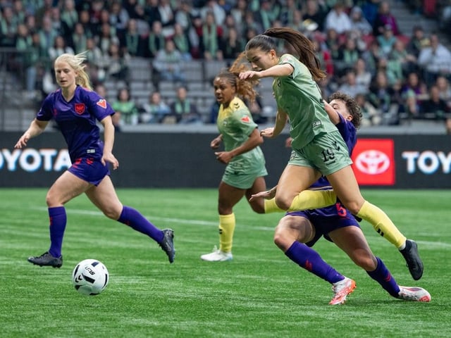 Vancouver Rise's Holly Ward (19) is tripped by Calgary Wild FC's Meikayla Moore (5) drawing a penalty shot during the first half of an NSL match in Vancouver on Wednesday, April 16, 2025.