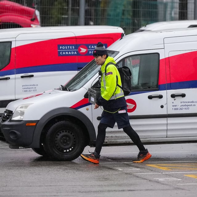 A Canada Post employee returns to a delivery depot in Vancouver, B.C., Tuesday, Dec. 17, 2024. THE CANADIAN PRESS/Darryl Dyck