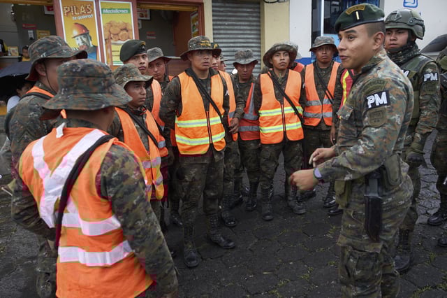 Soldiers receive instructions near the Fuego Volcano in San Juan Alotenango, Guatemala, Thursday, June 5, 2025, after the volcano's explosive activity increased. (AP Photo/Moises Castillo)