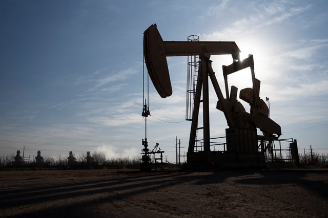A pump jack operates near a gas turbine power plant in the Permian Basin oil field outside of Odessa, Texas, U.S. February 18, 2025.  REUTERS/Eli Hartman/ File Photo