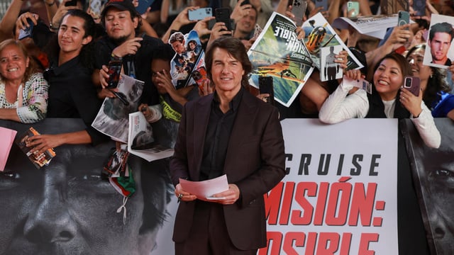 Tom Cruise posing for a picture as he attends the premiere of the film Mission: Impossible—The Final Reckoning at the Auditorio Nacional in Mexico City.
