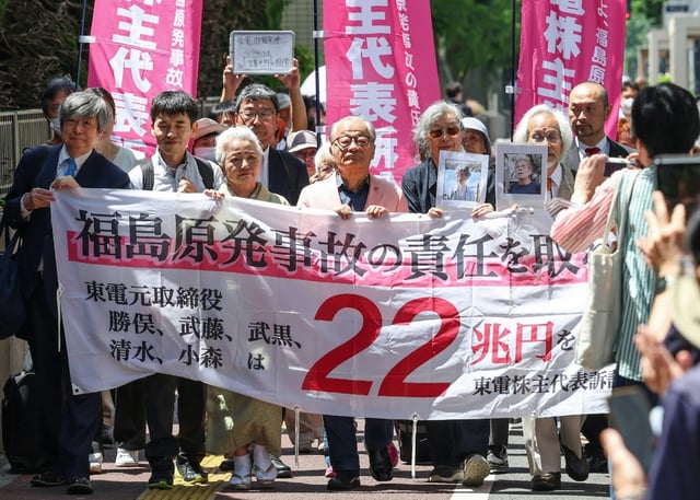'Take responsibility for the Fukushima nuclear accident!' a plaintiffs' banner said