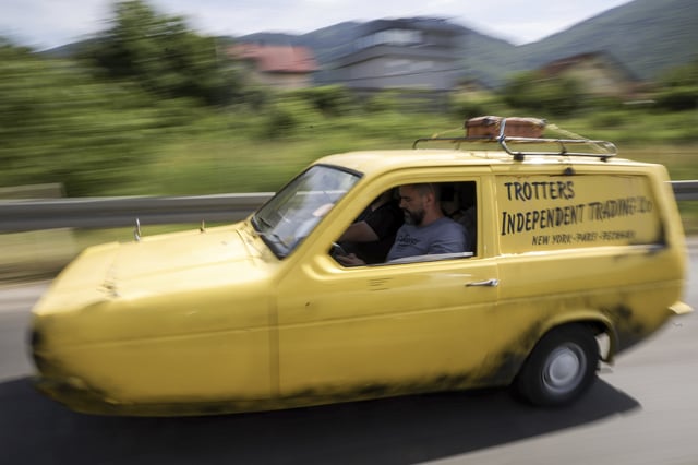 Tarik Fatic along with his brother Mirnes drives the Reliant Regal, an exact copy of the famous BBC TV show "Only Fools and Horses" iconic yellow car in Sarajevo, Bosnia, Wednesday, June 4, 2025. (AP Photo/Armin Durgut)