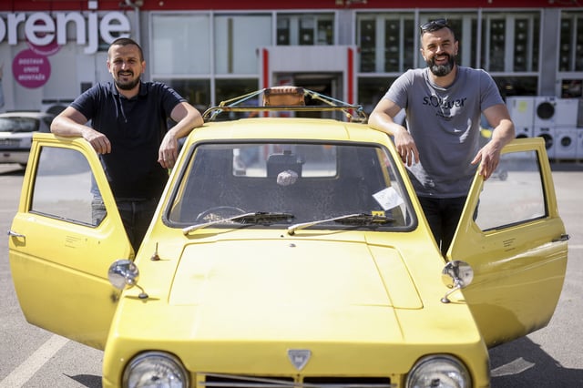 Tarik Fatic, left, and his brother Mirnes pose for a photo next to the Reliant Regal, an exact copy of the famous BBC TV show "Only Fools and Horses" iconic yellow car in Hadzici, suburb of Sarajevo, Bosnia, Wednesday, June 4, 2025. (AP Photo/Armin Durgut)