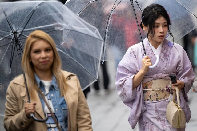 People visit a shopping street in Asakusa district near Sensoji Temple, a popular tourist location in Tokyo, during the last day of “Golden Week” holiday on May 6. Photo: AFP